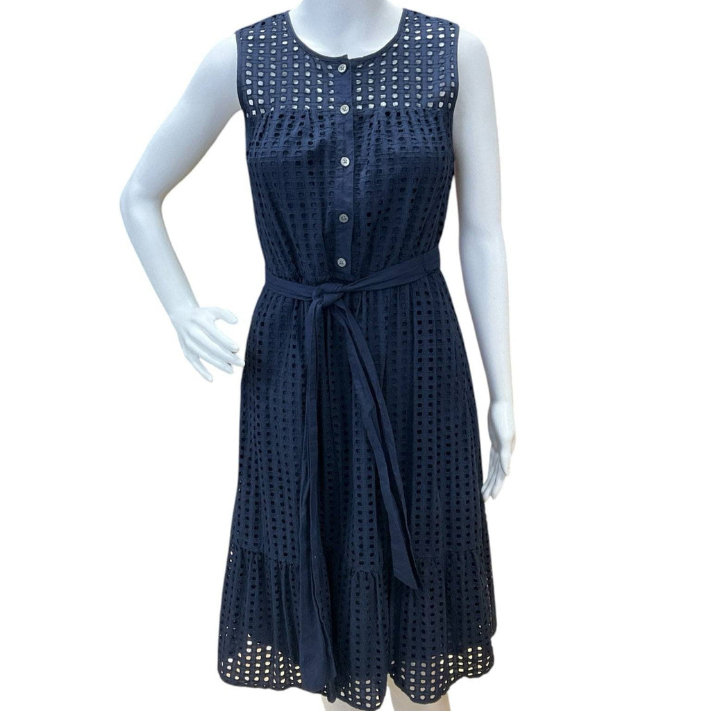 Front view of J Crew navy eyelet sleeveless dress Size 2 on mannequin with button-down bodice and waist tie. Shop at Margaret’s Fine Consignments.