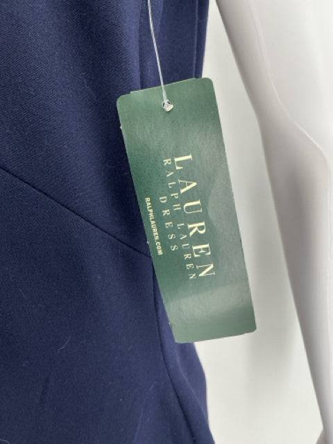 Lauren Ralph Lauren green brand tag attached to navy dress, confirming authenticity and new with tags status. Available at Margaret’s Consignments.