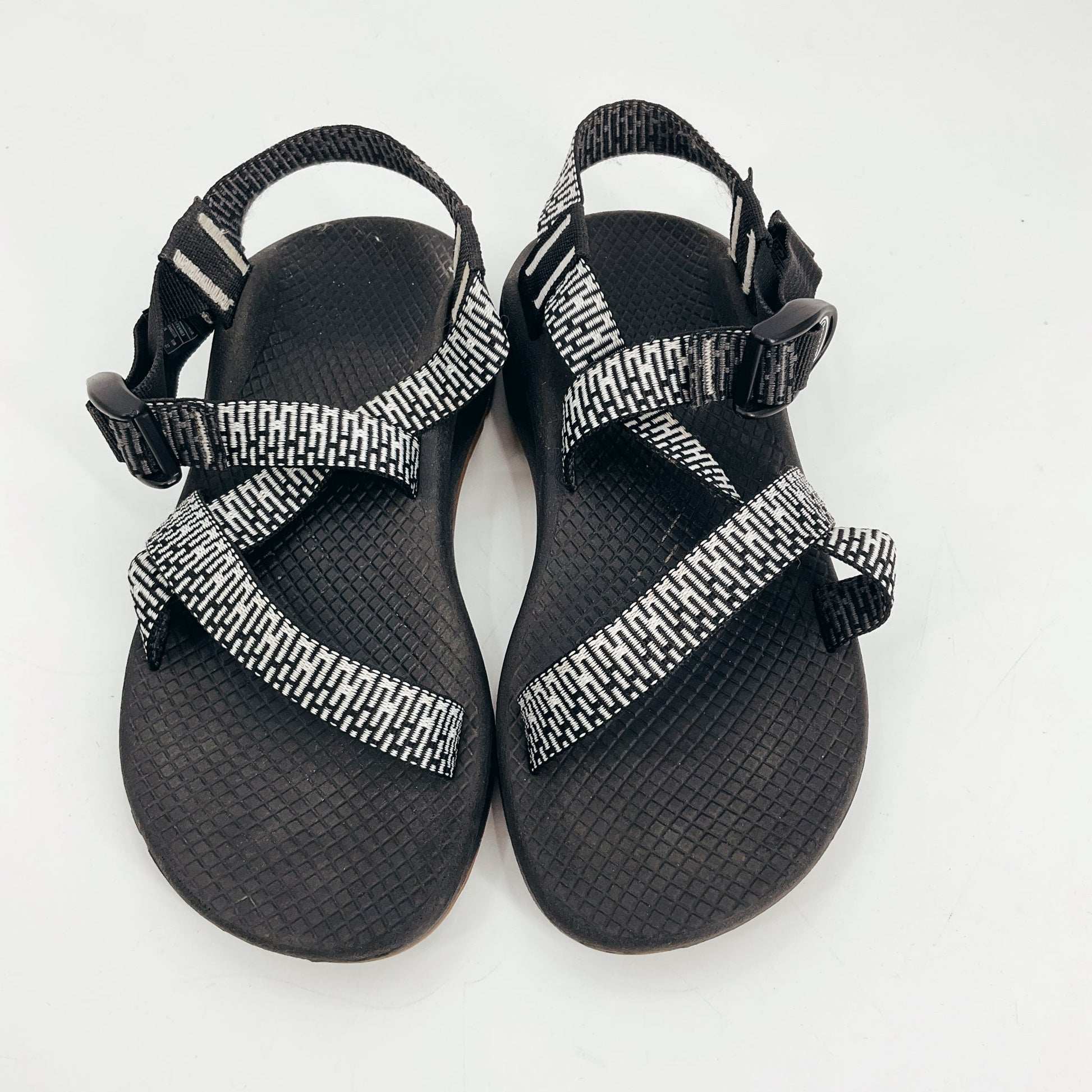 Top view of Chaco Black/White Print Pre-Owned Ladies Sandals - Size 6 with strappy design, ChacoGrip sole, and LUVSEAT footbed for hiking support.