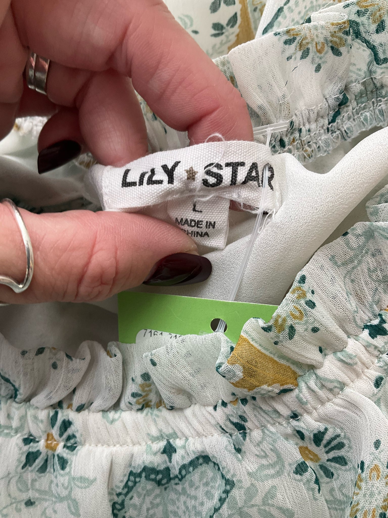 Teal and tan floral Lily Star sleeveless tunic blouse with tiered design and high neck, size large.