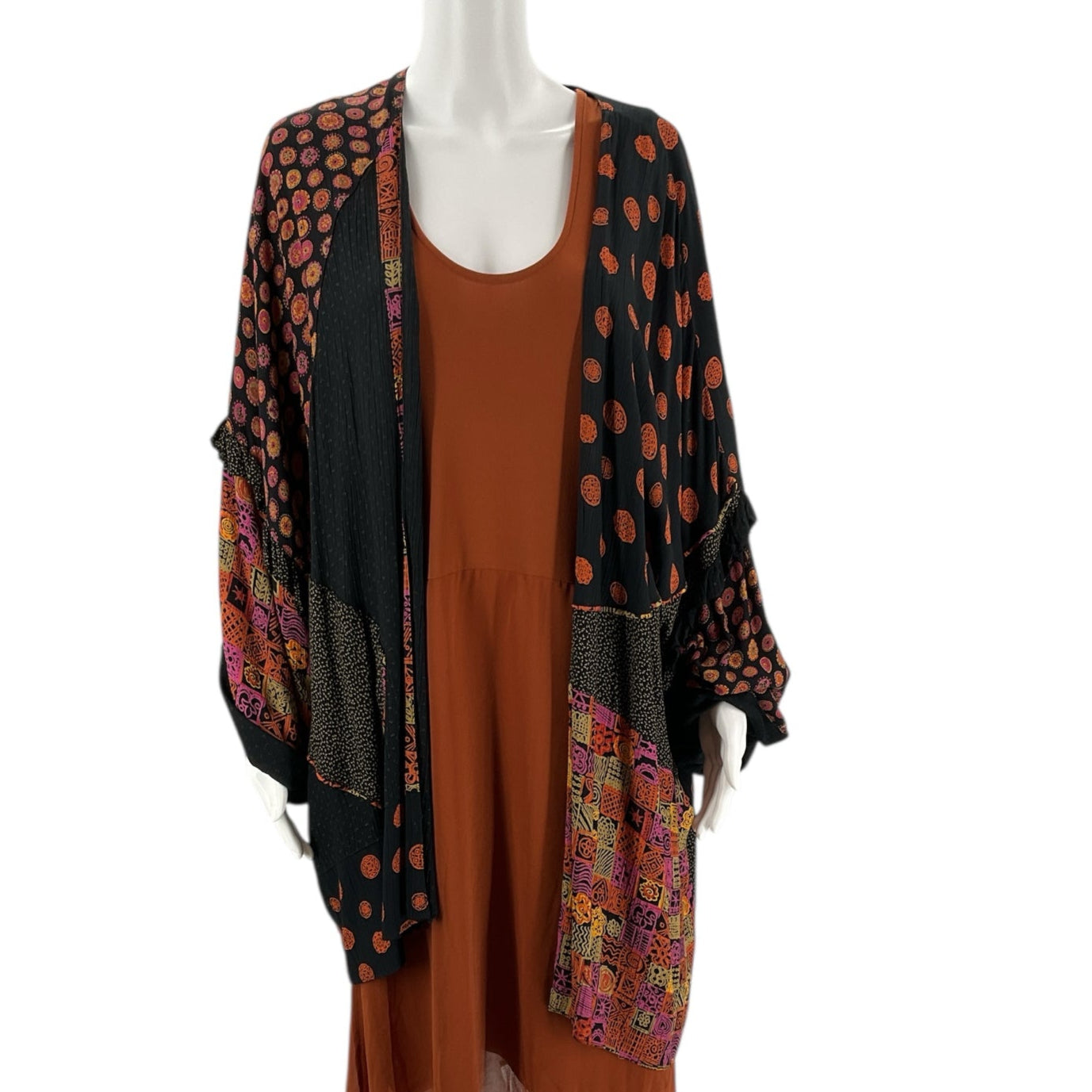 Colorful printed shrug in black, orange, and pink with polka dot and patchwork design, pre-owned women's sweater, one size fits most.