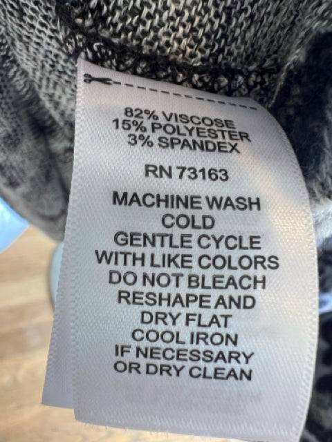 Close-up of Spense dress care label showing fabric composition and washing instructions for the size large animal print dress.