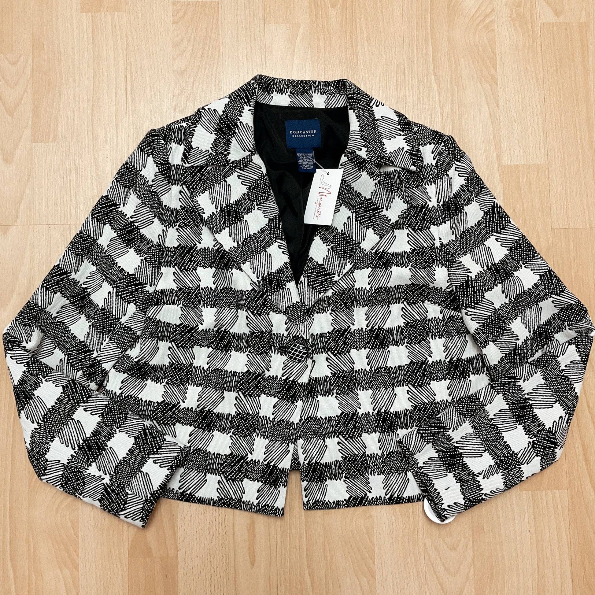 Pre-owned Doncaster Size 8 White/Black Print Blazer laid flat on wood floor, sustainable fashion with classic button-up style and structured fit.