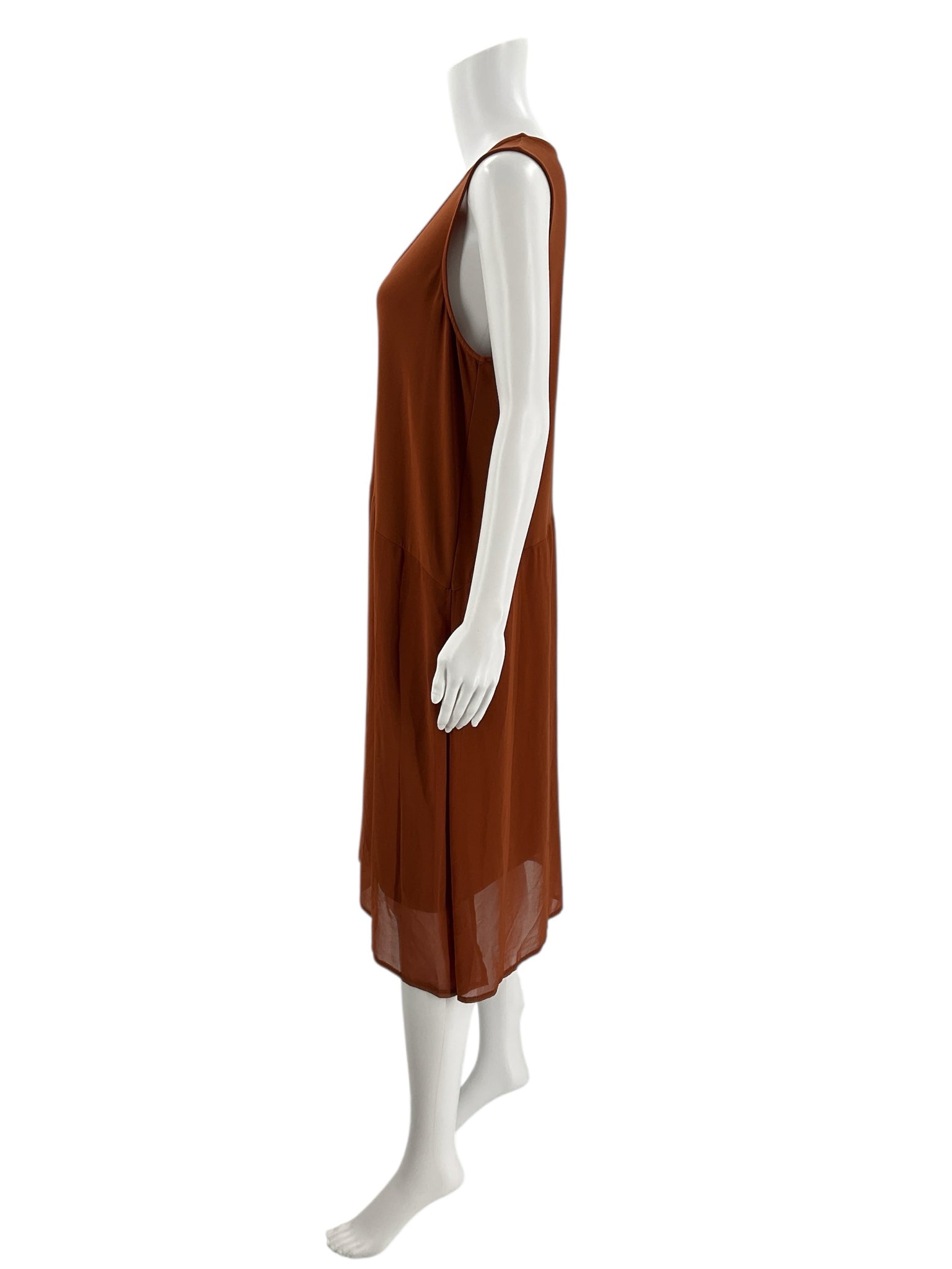 Side profile of DKNY Burnt Orange Pre-Owned Dress - Size XL on mannequin, showing the dress’s airy drape and sleeveless armholes.