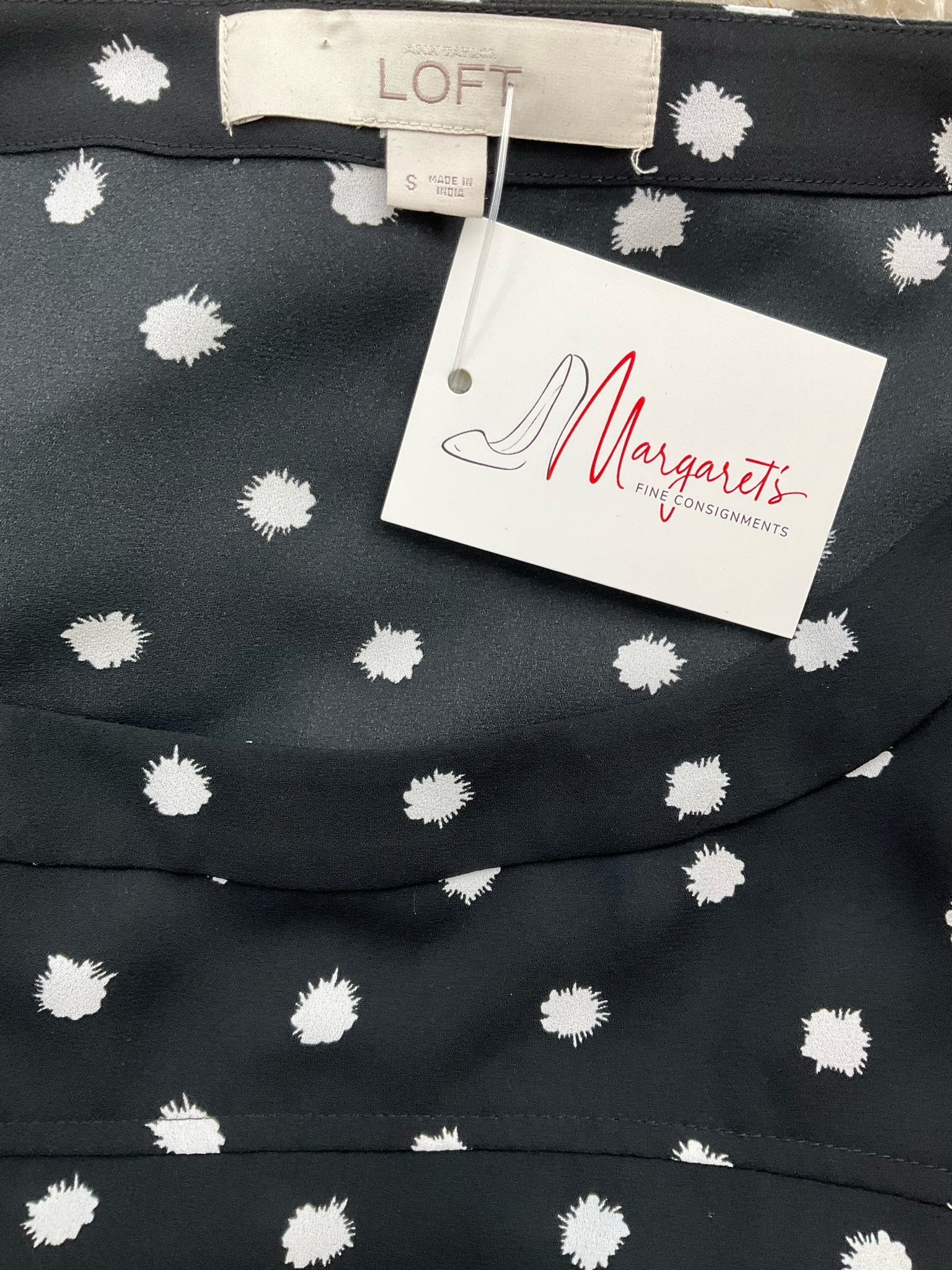 Ann Taylor LOFT pre-owned black and white polka dot boatneck top, A-line cut with high-low hem, size small.