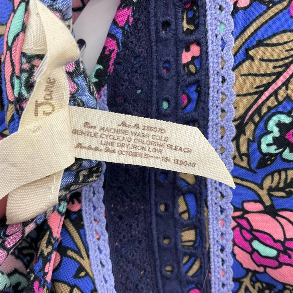 Fabric care label of Matilda Jane Dress Size Medium in blue/multi floral print, sold by Margaret’s Fine Consignments.