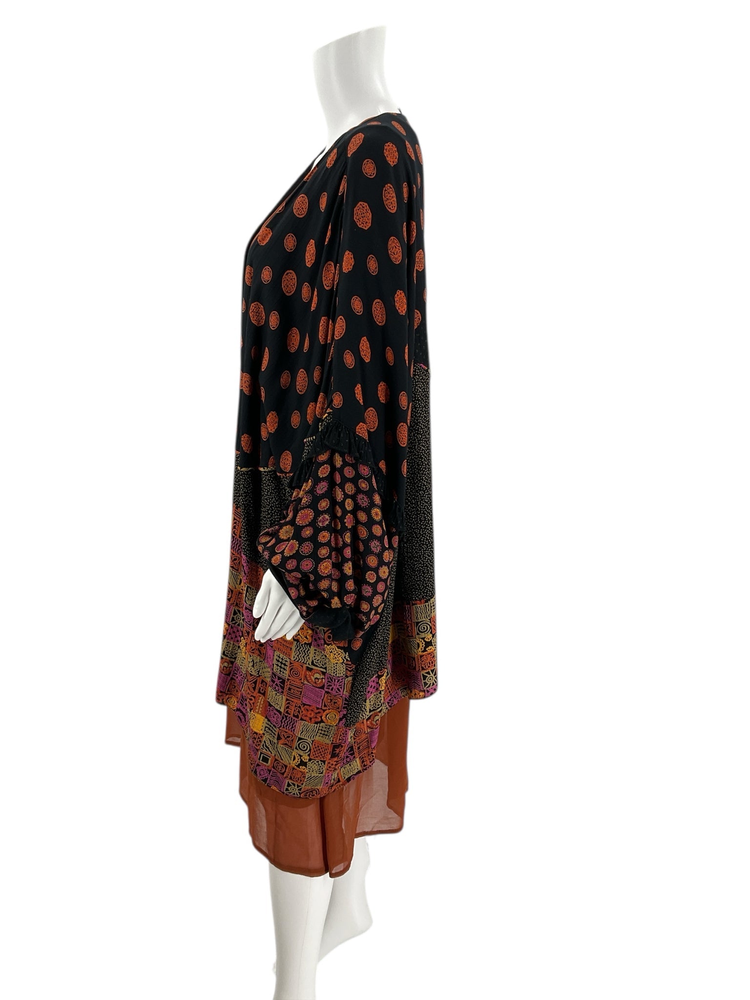 Side view of colorful printed shrug featuring polka dots and patchwork design, pre-owned women's sweater, one size fits most.