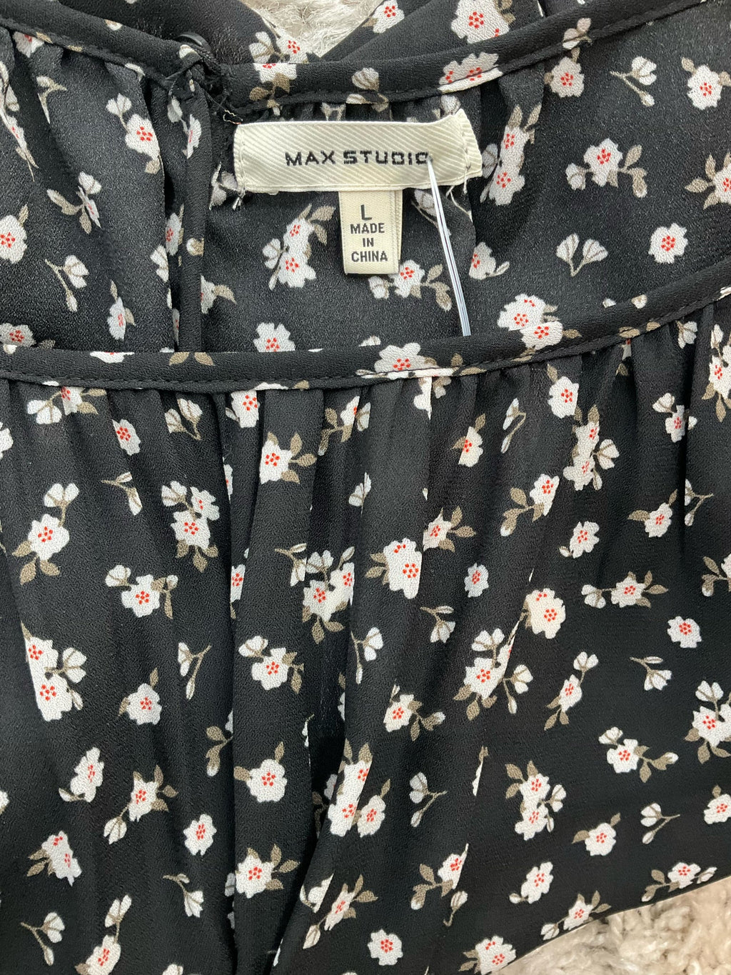 Max Studio white and black floral peasant top in size large, featuring a boho tunic style with romantic details.