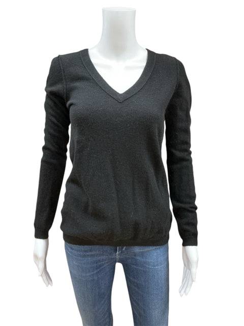 Close-up of Loft black solid V-neck top size medium in cashmere, displayed on mannequin with jeans at Margaret's Fine Consignments.