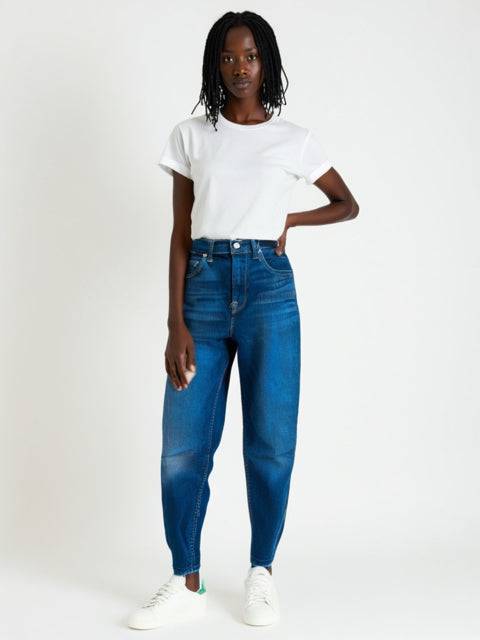 Model wearing For All Mankind Jeans Size 6 in dark blue, available at Margaret's Fine Consignments. Stylish pre-owned denim for casual wear.