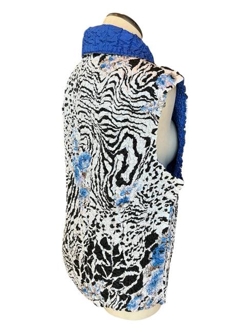 Back angled view of No Brand Vest Size M/L showing crinkle texture and mixed animal print with blue floral accents from Margaret’s Fine Consignments.