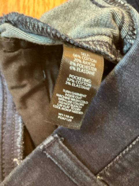Close-up of fabric care and material tag inside Betabrand Jeans Size Small Long, showing cotton blend composition.