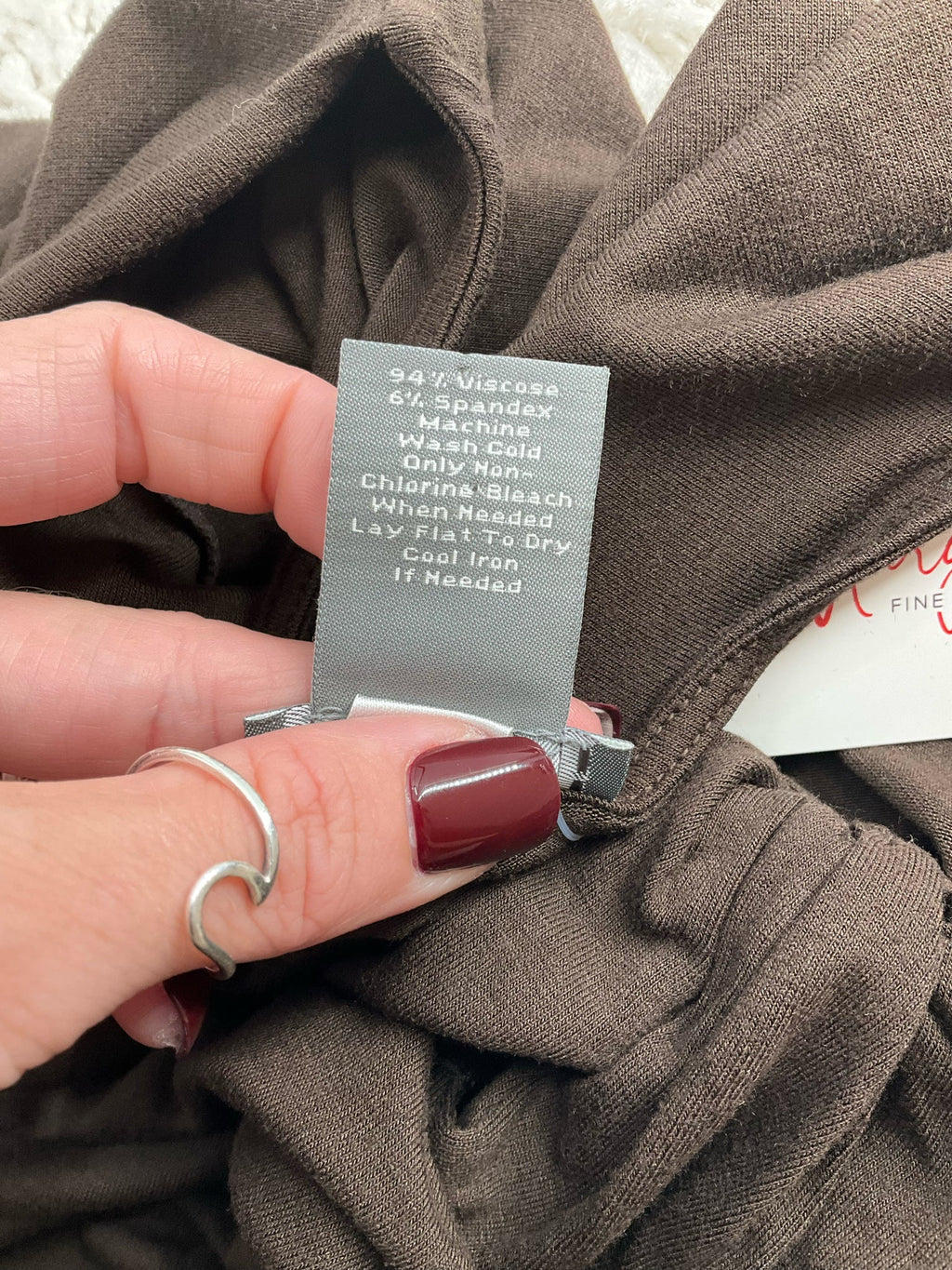 Ann Taylor brown knot front cap sleeve top in jersey knit, pre-owned size large, displayed on a hanger.