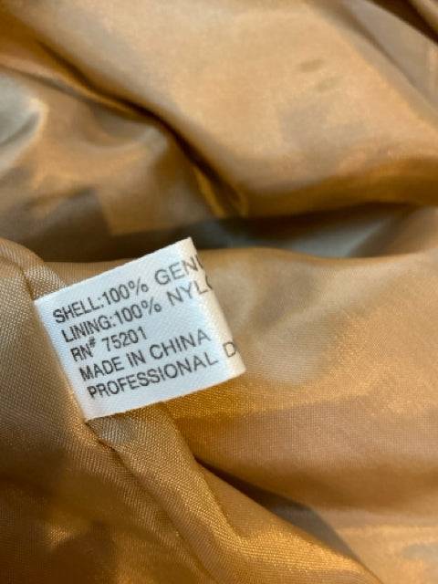 Close-up of interior label on Orvis Leather Jacket Size Large showing 100% genuine leather shell and nylon lining, dry clean only.