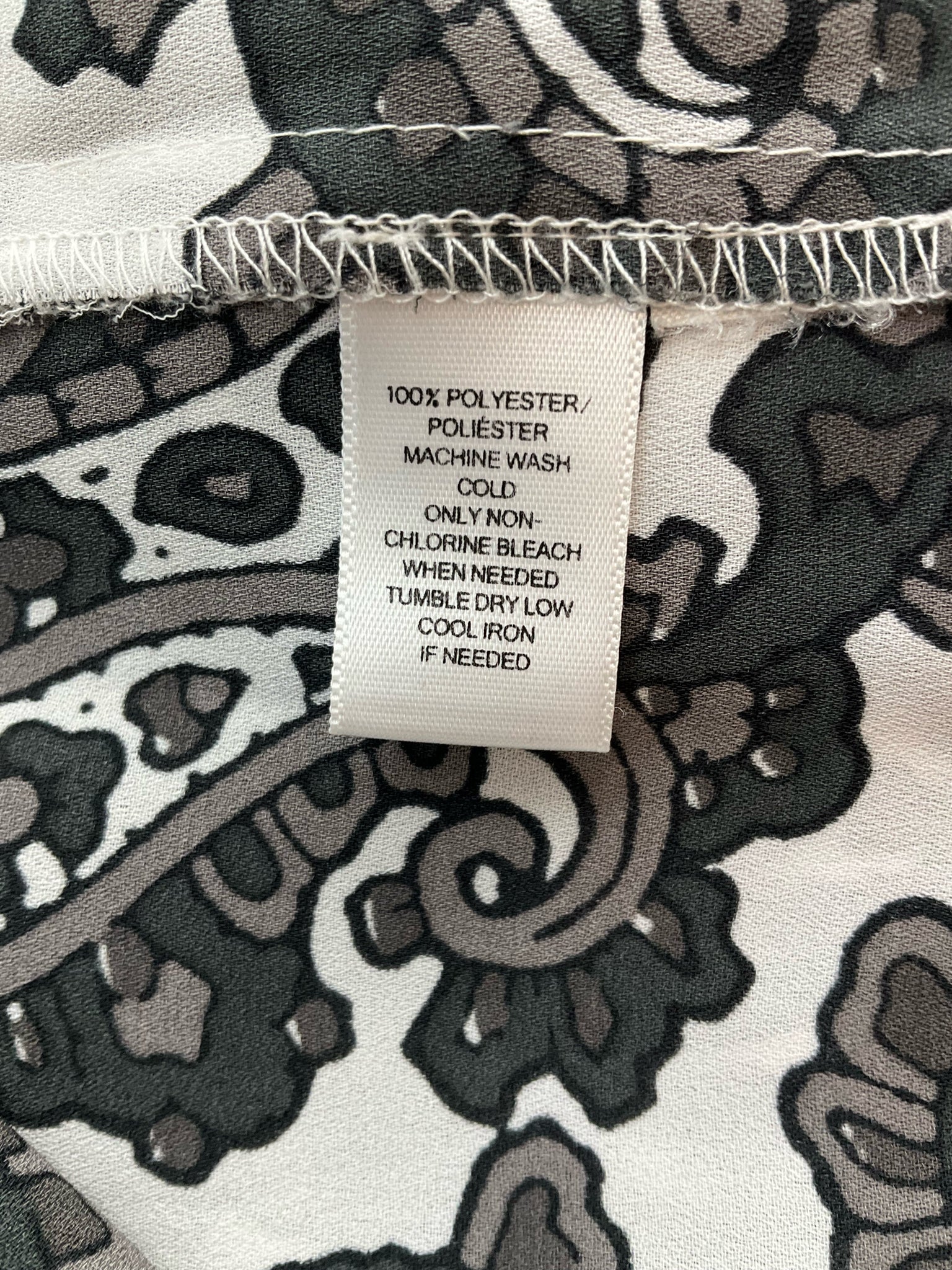 Ann Taylor Loft long sleeve blouse in black, white, and gray paisley pattern, size XS, scoop neck pullover style.