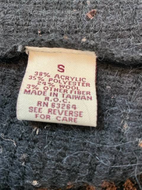 Fabric tag of Yvos Shrug Size Small showing material blend and care instructions, confirming authenticity and composition for resale.