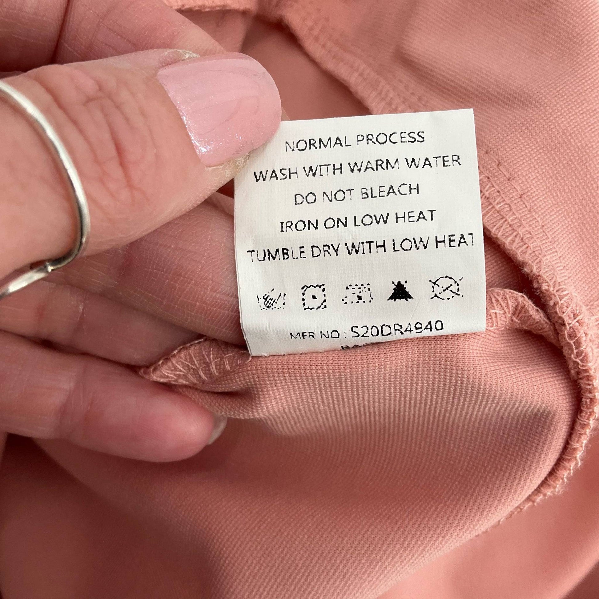 Care label for Simplee Dress Size Large with washing instructions, part of Margaret’s Fine Consignments pre-loved dress collection.