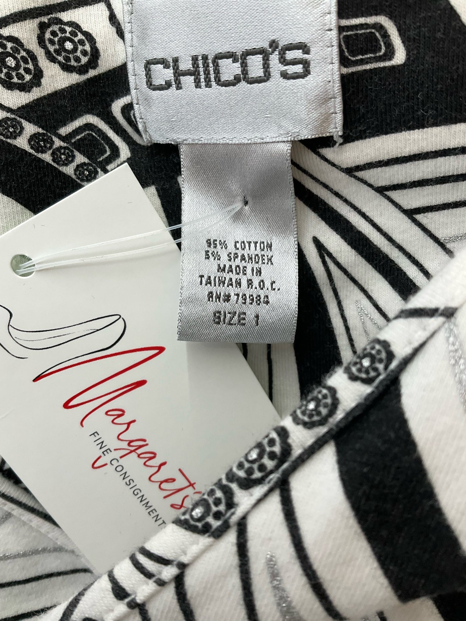 Chico's V-Neck Pullover Top in white and black print, pre-owned, size medium, displayed flat on a neutral background.