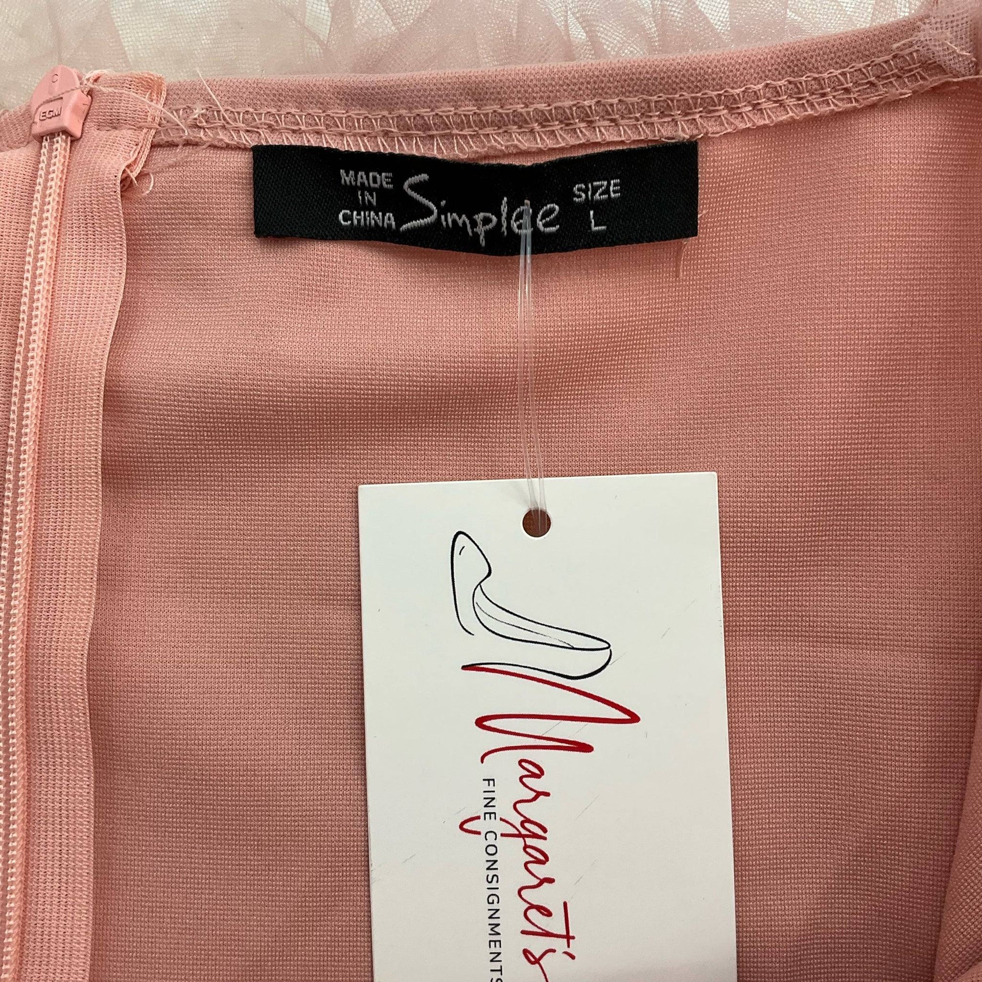 Close-up of Simplee brand label and size tag 'L' on pink mesh dress, featured at Margaret’s Fine Consignments for chic resale fashion.