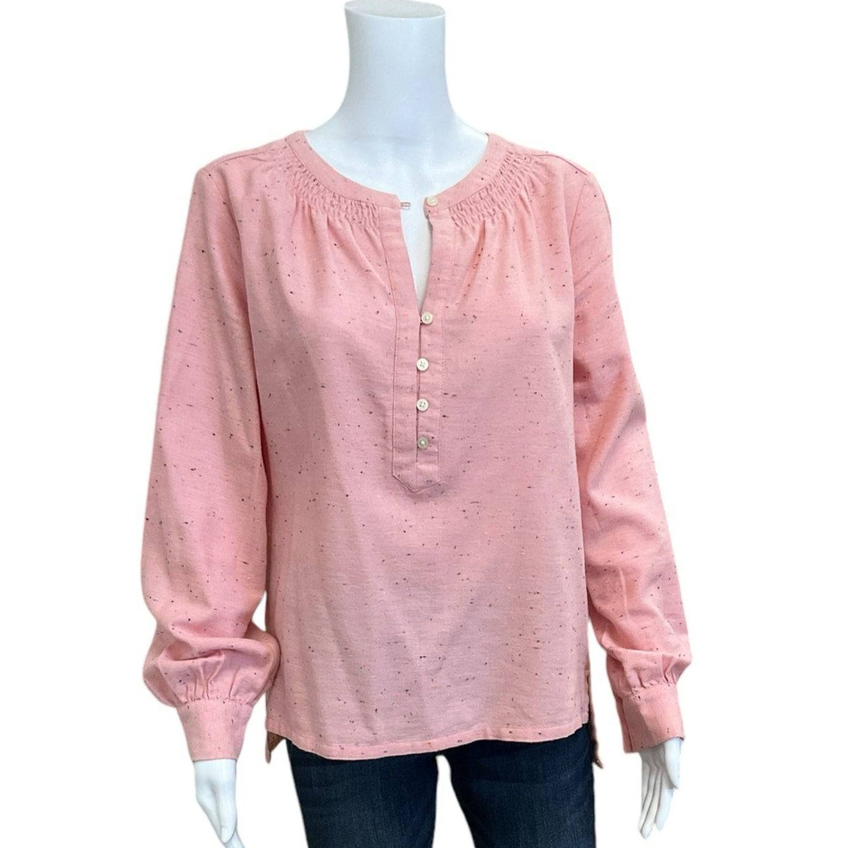 Loft Pink Speckled Top Size Small displayed on mannequin with jeans, featuring long sleeves, smocked neckline, and front buttons. Shop at Margaret’s Fine Consignments.