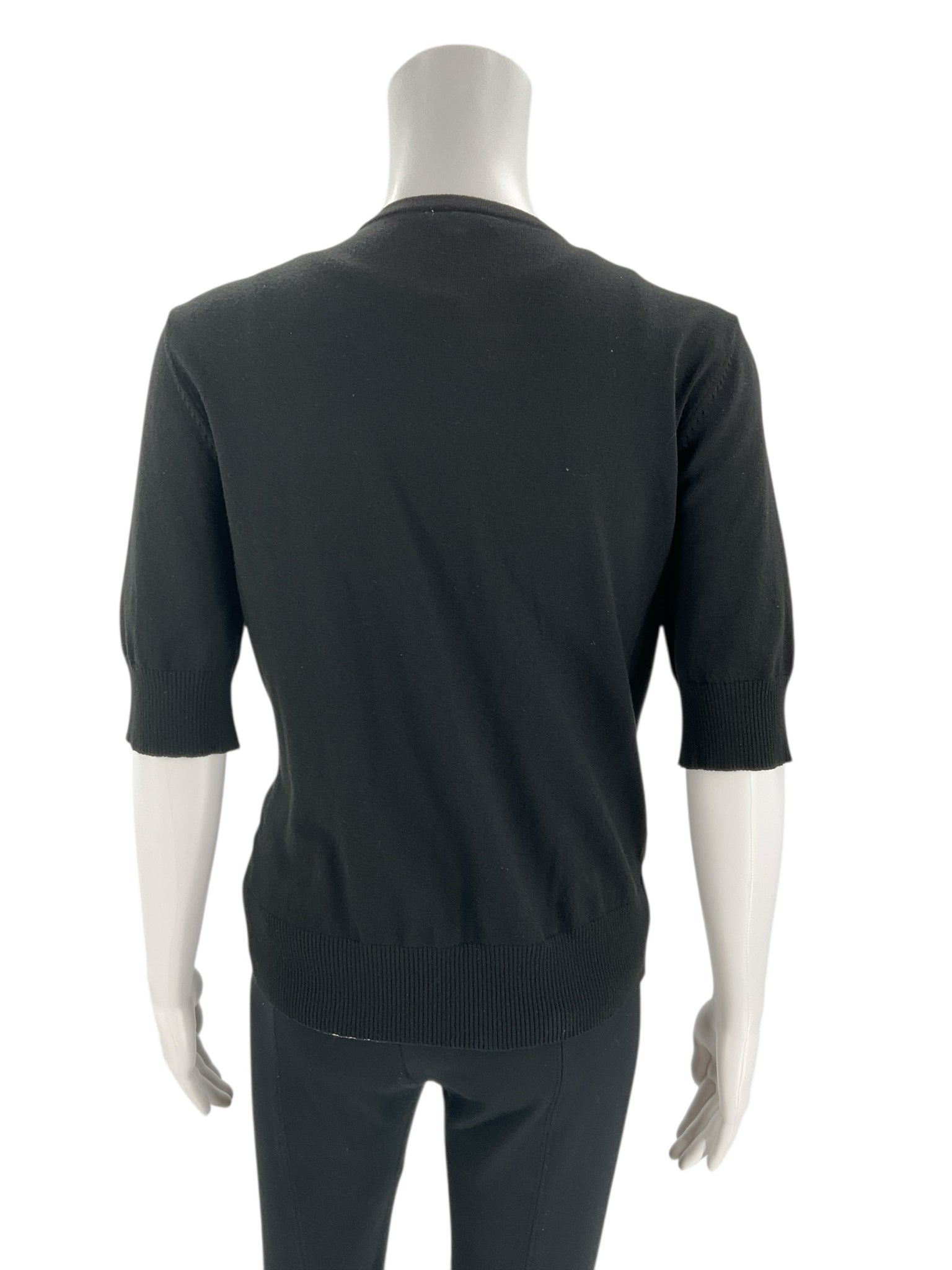 Back view of Ann Taylor black solid shrug in size L, featuring ribbed hem and cuffs for a fitted, classic silhouette.