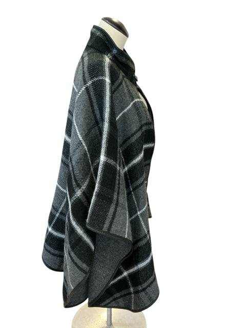 Side view of Lucky Belle plaid poncho in black and gray tones, cozy outerwear in one size fits most from Margaret’s Fine Consignments.