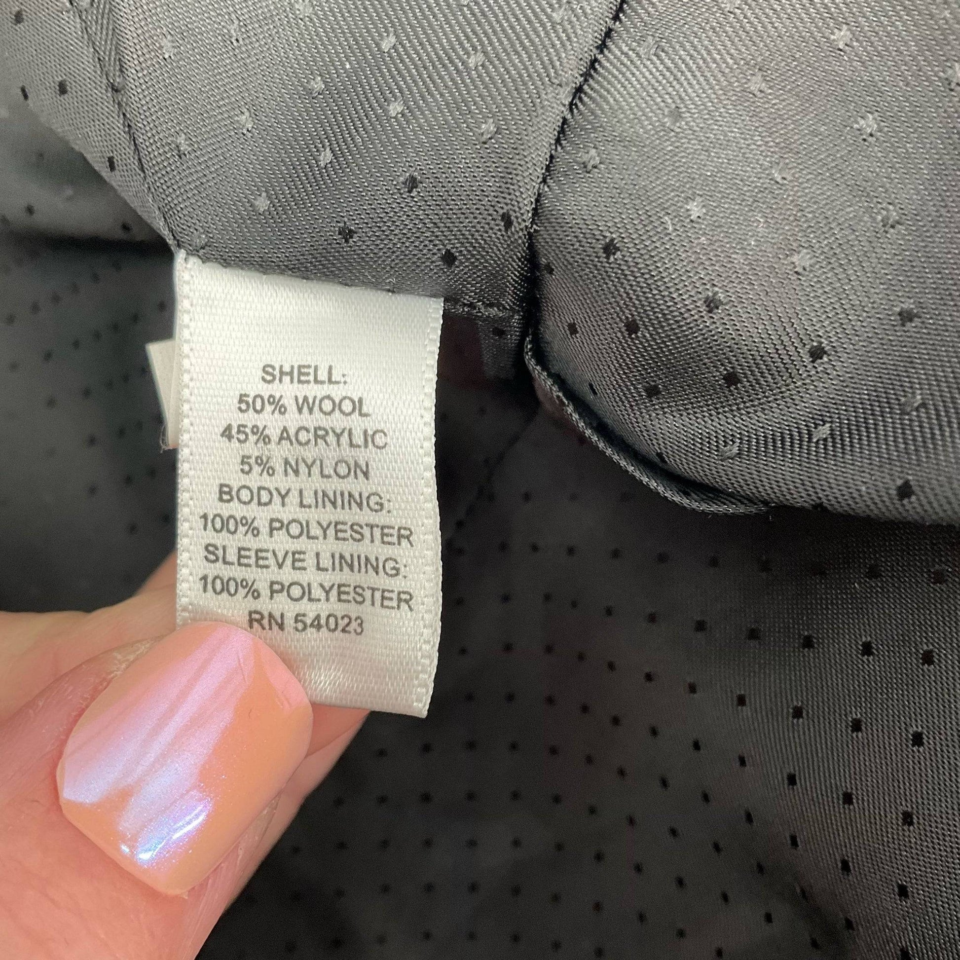 Fabric content tag of Banana Republic Black Textured Wool-Blend Coat – Size XS showing 50% wool blend for warmth and durability.