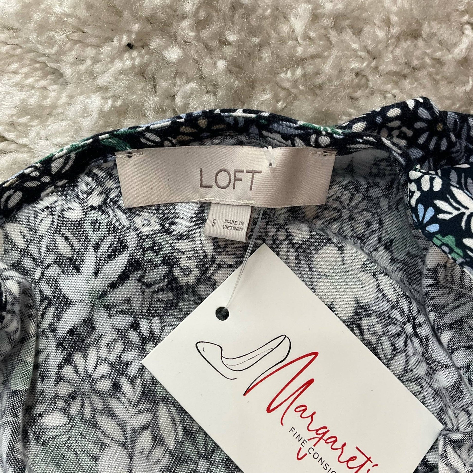 Close-up of Loft brand tag and Margaret's Fine Consignments label on the Navy/Multi Floral Blouse - Size Small, confirming authenticity.