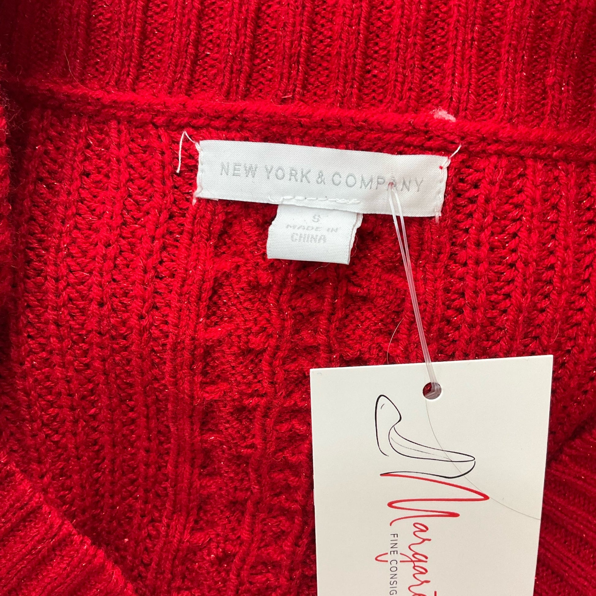 Close-up of New York & Co brand label on red sweater top, size small, confirming authenticity for second-hand women’s apparel.