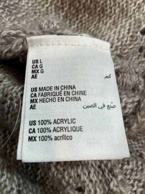 Fabric tag of Karen Scott Shrug Size Large showing 100% acrylic material and manufacturing details, featured at Margaret’s Fine Consignments.