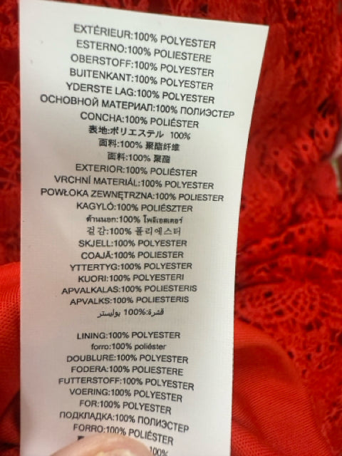 Fabric composition tag of Michael Kors red lace dress, showing 100% polyester shell and lining, ideal for preloved designer fashion buyers.