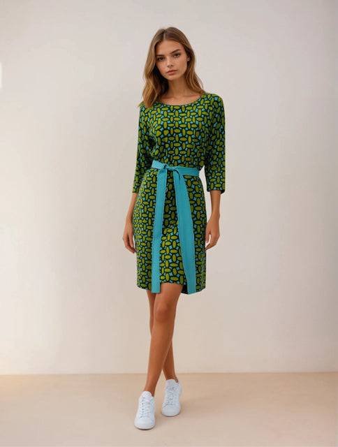 Boden Dress Size 4 in green and teal geometric print with blue waist tie, modeled for Margaret’s Fine Consignments. A vibrant casual dress option.