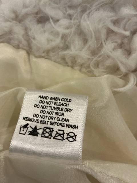 Care label for J.J. Winter Vest Size Medium with hand wash instructions and fabric care symbols. Find it at Margaret’s Fine Consignments.