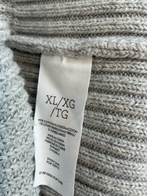 Close-up of Cabi Shrug Size XL fabric tag showing cotton blend material and size details. Shop this stylish piece at Margaret’s Fine Consignments.