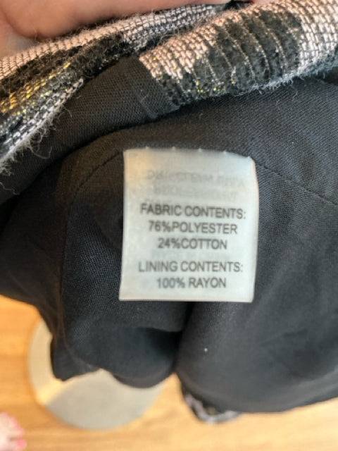 Close-up of Dolce Cabo Jacket fabric tag showing 76% polyester, 24% cotton outer and 100% rayon lining, confirming material details.