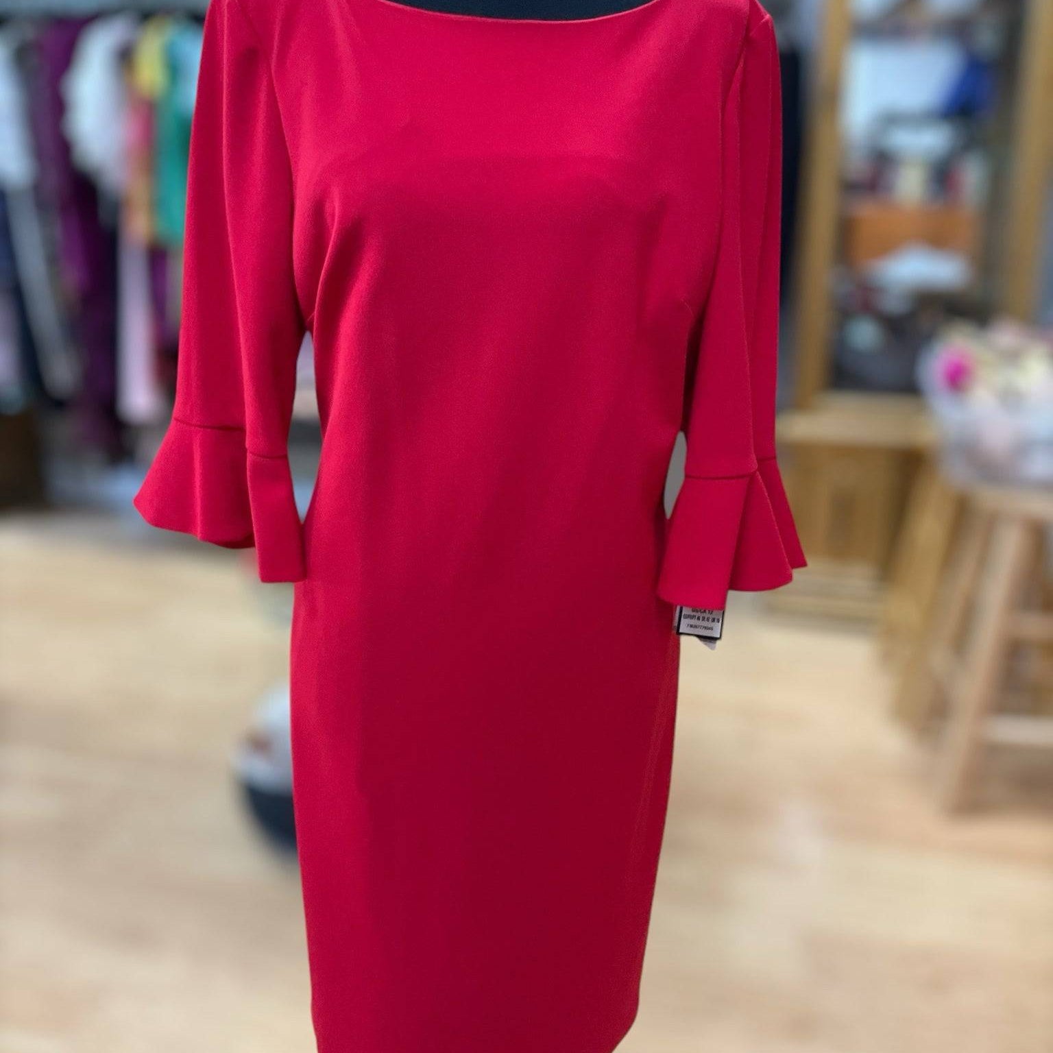 New with tags Nine West red dress size 12 displayed on mannequin at Margaret’s Fine Consignments. Elegant choice for formal or semi-formal events.