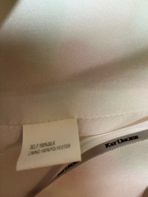Close-up of fabric tag showing 100% silk material of Kay Unger White/Green/Pink Print Pre-Owned Ladies Dress - Size 10, emphasizing luxury quality.